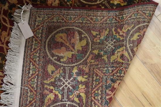 An Afghan red ground rug 216cm x 146cm